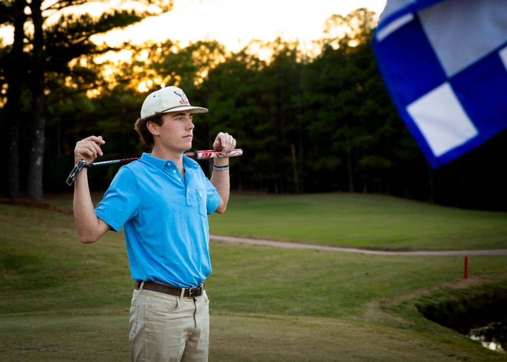 Senior portrait on a golf course at golden hour